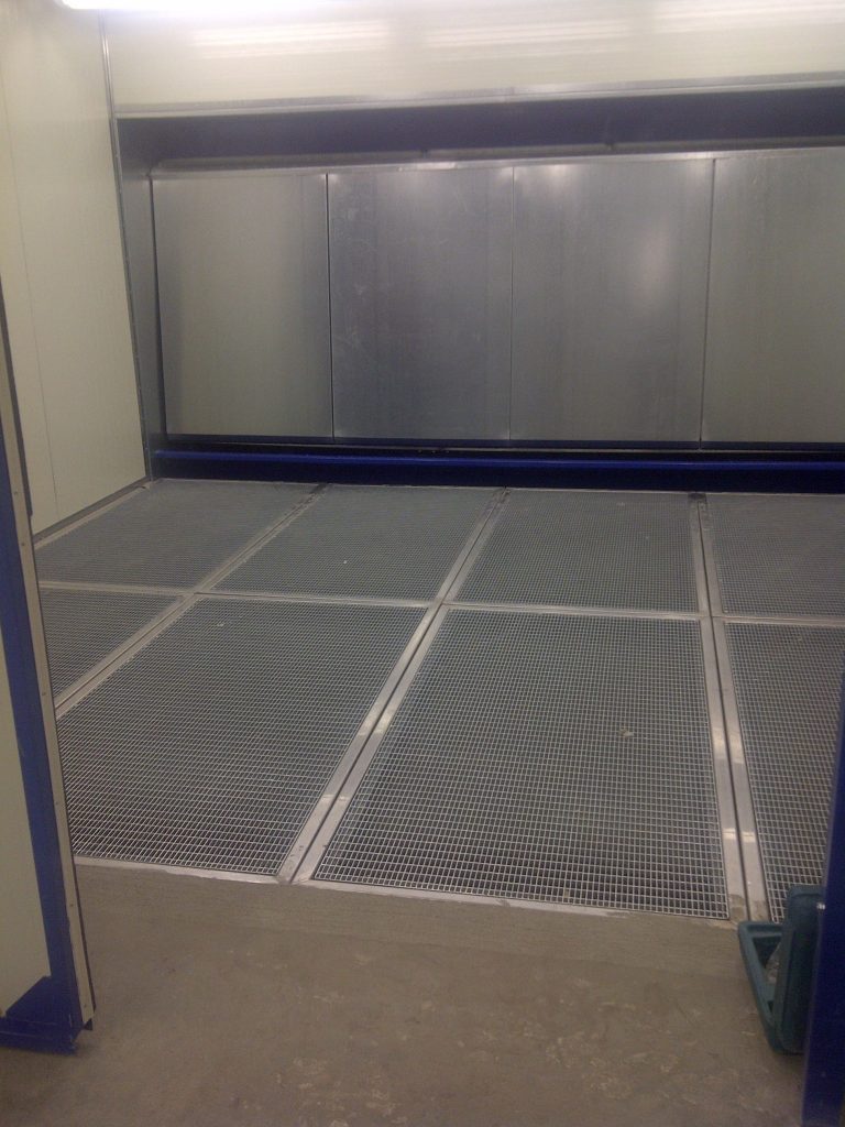 Interior of an ALWO enclosure with wet extraction wall and grated metal floor